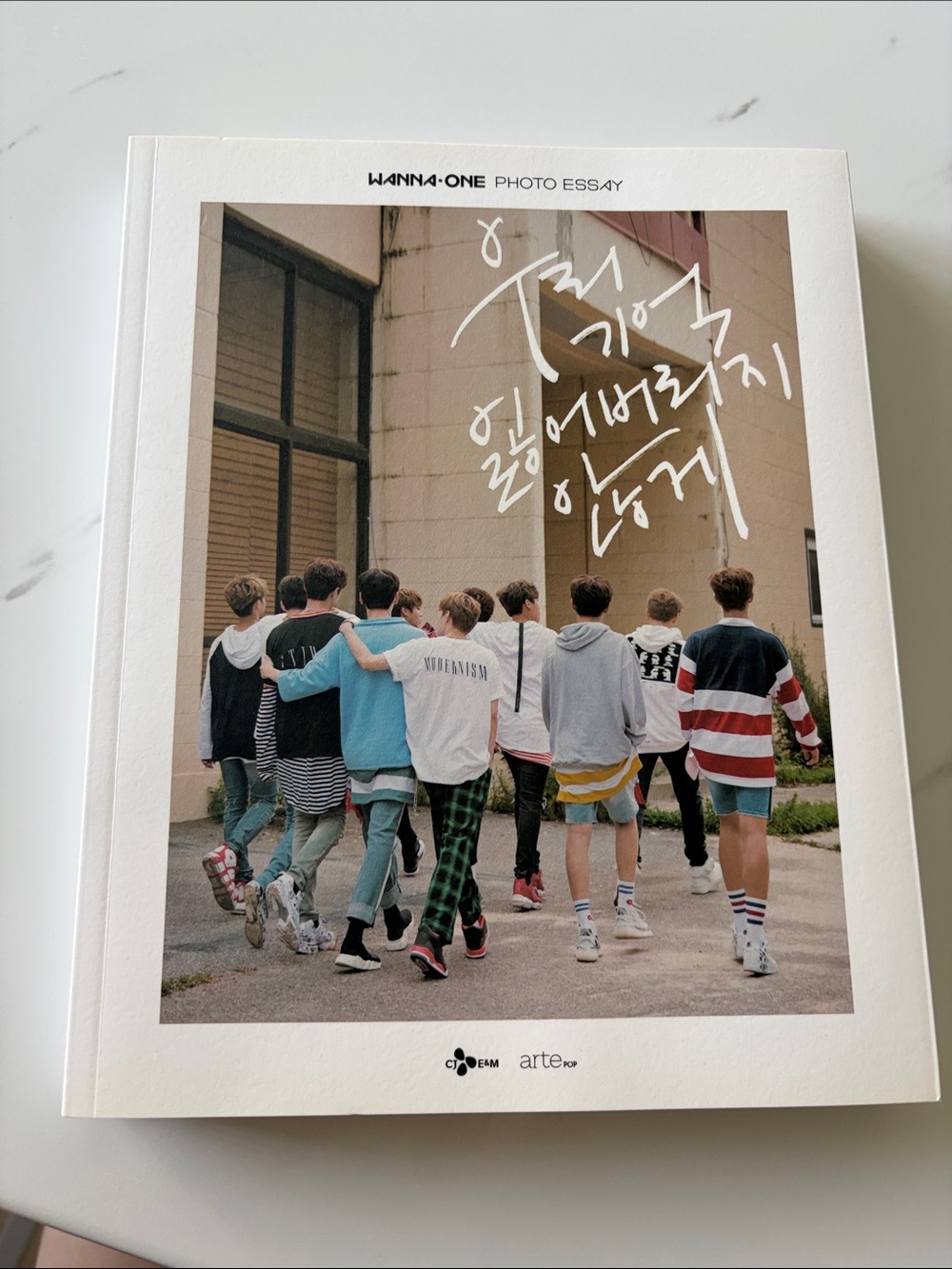 Wanna One Photo Essay book titled "우리 기억 잃어버리지 않게" (Lest We Forget Our Memories)